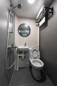 a bathroom with a toilet and a sink and a shower at Studio Stay in Hong Kong