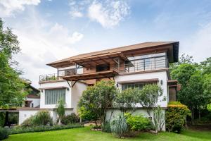 a house with a garden in front of it at The Pig House Khao Yai - SHA Plus in Mu Si