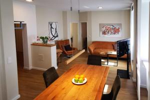 a living room with a table with a plate of fruit on it at Esprit-Apart-Hotel in Baden-Baden