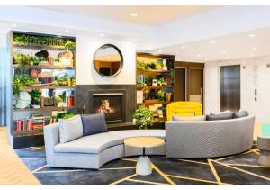a living room with a couch and a fireplace at Brady Apartment Hotel Flinders Street in Melbourne