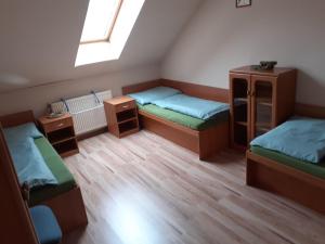 a room with three bunk beds and a window at Hostel Fontana in Žilina