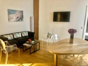 a living room with a couch and a table at Appartements Urban et Pure in Cannes