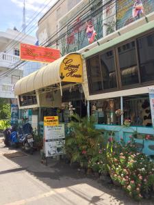a store with a sign in front of a building at King's Home Hua Hin Homestay in Hua Hin