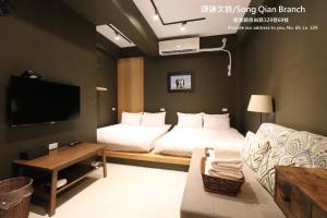 sala de estar con 2 camas y sofá en 頌謙文旅 梅花鹿同住, en Lukang