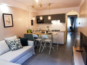 a living room and a kitchen with a couch and a table at La CasAffittiera Apartments Group in Anzio
