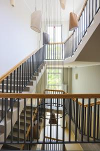 a winding staircase in a building with chairs and lights at Apartamenty Świnoujście - Wyspiańskiego 34e in Świnoujście