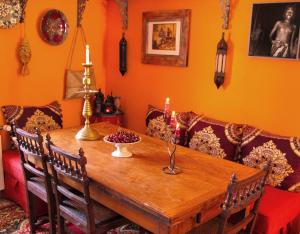 a dining room with a wooden table with two candles at B&B in Arles "L'Atelier du Midi" chambre d'hôtes centre historique ARLES in Arles