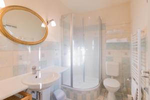 a bathroom with a shower and a sink and a toilet at Ferienhaussiedlung Strandperlen Küstenhof 3d (Typ IV) in Wustrow +15 photos