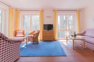 a living room with a couch and a tv at Landhaus DADDELDU Whg. V-D2 (hinten) in Ahrenshoop