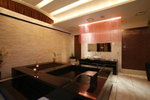 a large bathroom with a large tub and a table at Chateau Boutique Motel in Taichung