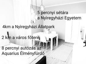 a room with a table and a table and a dining room at Lora Apartman in Nyíregyháza