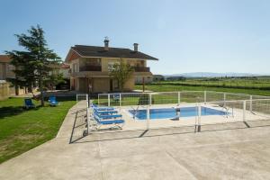 a house with a swimming pool and a house at Villa Oasis de Bardenas & Piscina in Valtierra