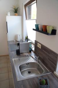 a kitchen counter with a sink in a kitchen at Ferienwohnung naehe Freiburg FeWo in Holzhausen