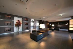 a lobby with couches and a vase of flowers at Center One Hotel Handa in Handa