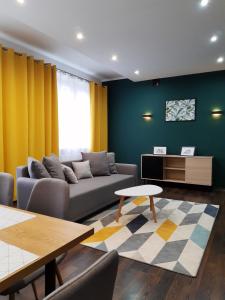 a living room with a couch and a table at Emerald Apartament in Białystok