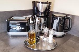 a counter with a coffee maker and a toaster and glasses at Ferienwohnung Wagner in Neumagen-Dhron