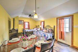 a dining room with a table and a bed at Pet-Friendly Poconos Abode - Pool, Pond and Fire Pit in Pleasant Mount