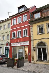 a red building on the side of a street at Ferienapartments Volkach in Volkach