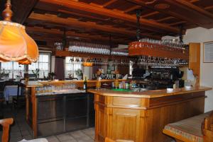 a bar in a restaurant with glasses on the shelves at Gasthof Knappenwirt in Tamsweg