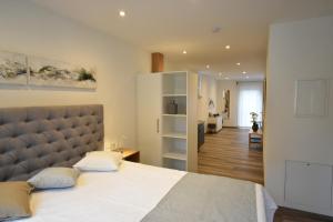 a bedroom with a large bed and a living room at Ferienapartments Volkach in Volkach