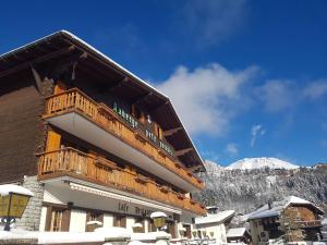 a building with a balcony on top of it in the snow at Petit Paradis in Crans-Montana