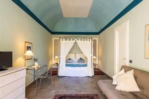 a bedroom with a bed with a canopy at B&B Sant'Agostino in Palermo