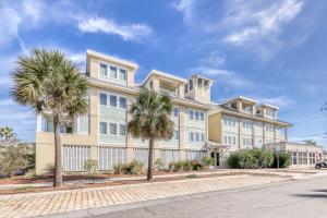 a large building with palm trees in front of it at Tybee Escape in Tybee Island