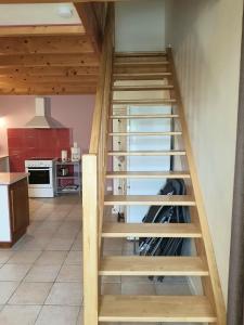 a wooden wine cellar staircase in a kitchen at Terrasse & Jardin in Jonzac +2 photos