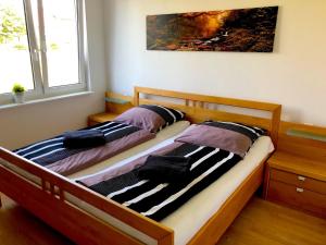 two twin beds in a room with at Dreamapartment La Vigna Living mit eigenem Aussenpool & Sauna - Weil am Rhein in Weil am Rhein +16 photos