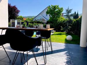 a table and chairs sitting on a patio at Dreamapartment La Vigna Living mit eigenem Aussenpool & Sauna - Weil am Rhein in Weil am Rhein