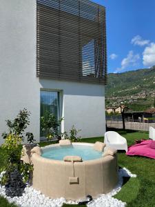 a hot tub in the backyard of a house at Art B&B Design in Costa Volpino