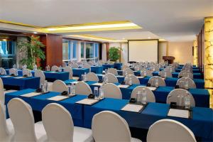 a conference room with blue tables and white chairs at Beijing Kuntai Royal Hotel in Beijing