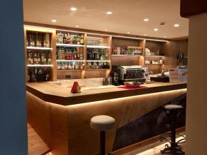 a bar in a restaurant with a counter top at Hotel Patrizia Dolomites Glamour in Moena