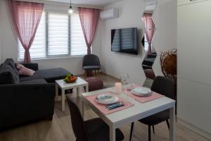 a living room with a table and a couch at SOS CoMFORT in Burgas