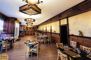 an empty dining room with tables and chairs at Hotel Saftica in Săftica
