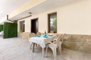 a table and chairs on the patio of a house at Apartments Flora 1 in Burgas