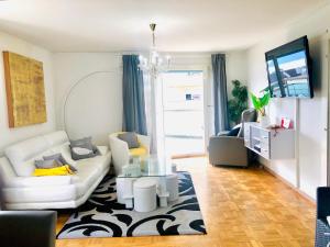 a living room with a white couch and a table at Lake & Mountain View Apartment I 27 in Montreux