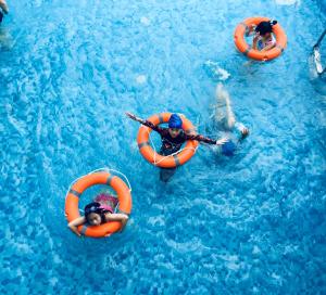 a group of people in orange tubes in the water at Phoenix Hotel Hà Giang in Ha Giang