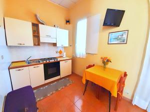 a kitchen with a table with a yellow table cloth at Hotel Alba Torino centro in Turin