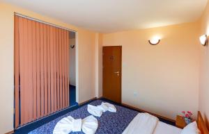a hotel room with a bed with bows on it at Family Hotel Jemelly in Obzor