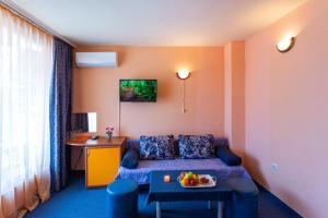 a living room with a couch and a table at Family Hotel Jemelly in Obzor