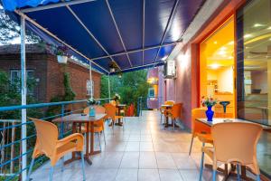 a balcony of a restaurant with tables and chairs at Family Hotel Jemelly in Obzor
