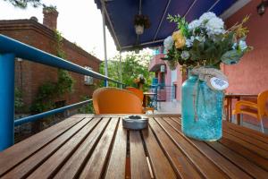 a vase of flowers sitting on a wooden table at Family Hotel Jemelly in Obzor