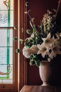 a vase of flowers sitting on a table next to a window at Barossa Dreams in Tanunda