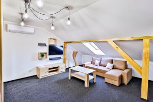 a living room with a couch and a table at Targowa37 Uniejow in Uniejow