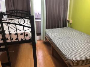 a bedroom with two bunk beds and a window at Yasuragi Nakasu in Fukuoka +8 photos