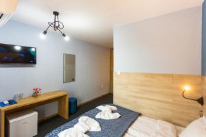 a hotel room with a bed and a desk at Family Hotel Jemelly in Obzor