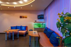 a room with a couch and a table and a fish tank at Family Hotel Jemelly in Obzor