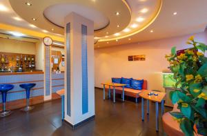 a restaurant with a clock on the ceiling at Family Hotel Jemelly in Obzor