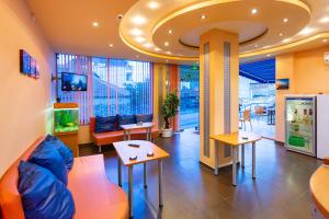 a lobby with a fish tank in a room at Family Hotel Jemelly in Obzor
